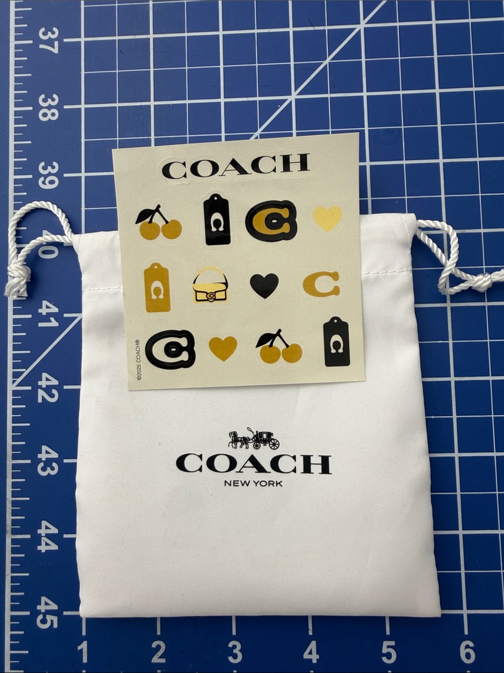Coach White Drawstring Dust Pouch with Black Logo includes Coach stickers.